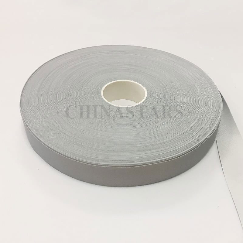 Single sided reflective spandex piping for binding tape