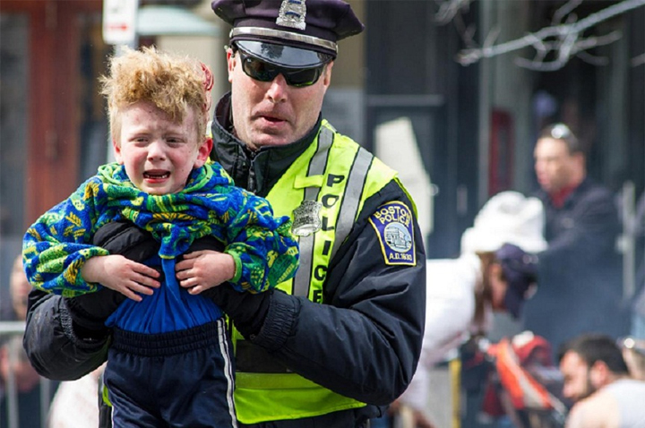 Police in safety vest help lost child back home